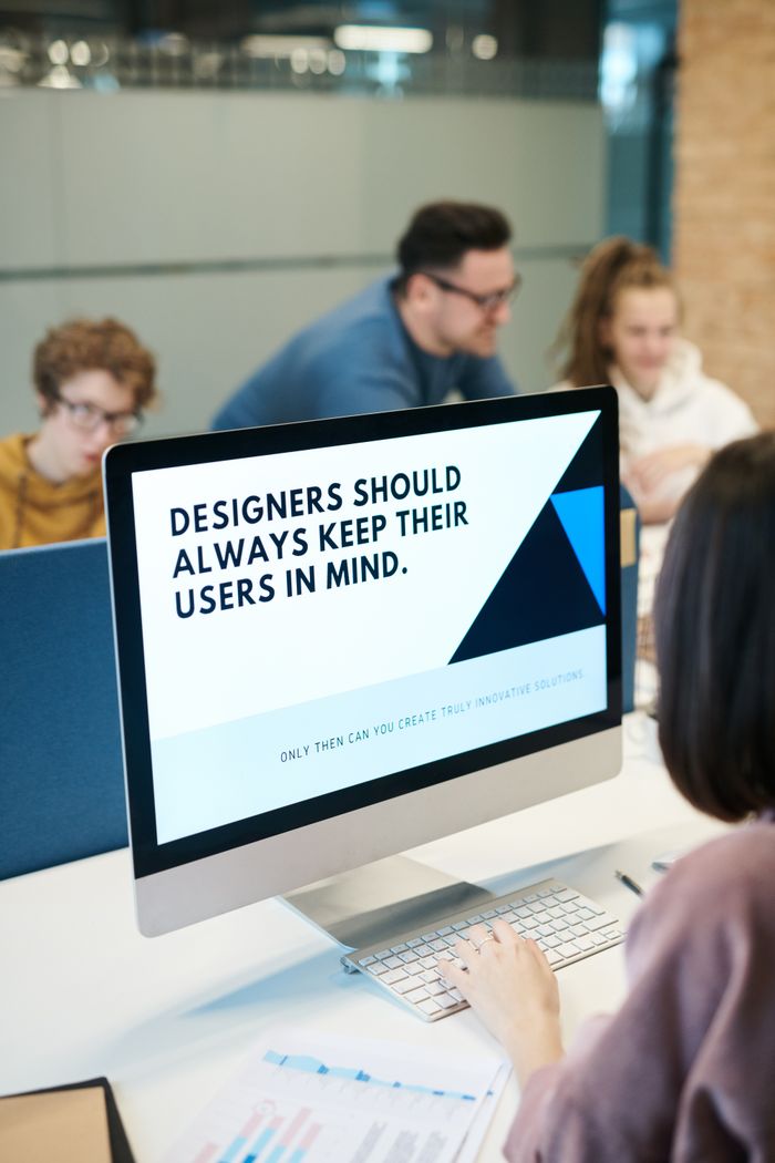 Team of designers working together in a contemporary office with a computer.